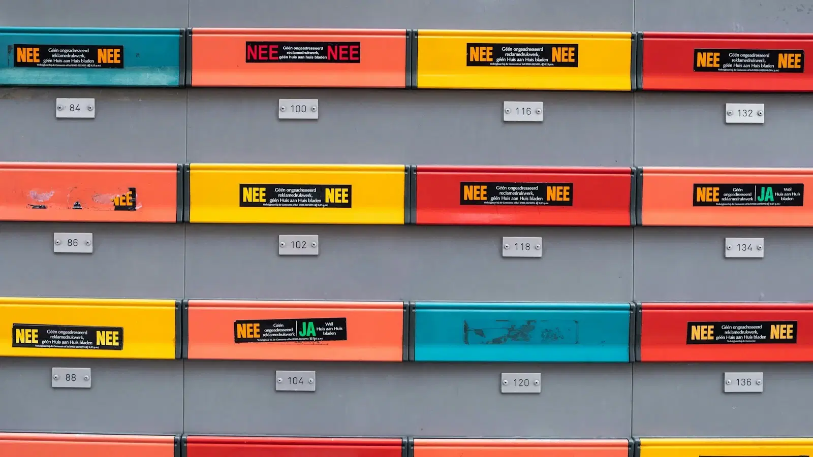 Rows of small labelled file-cabinet tags in different colours.
