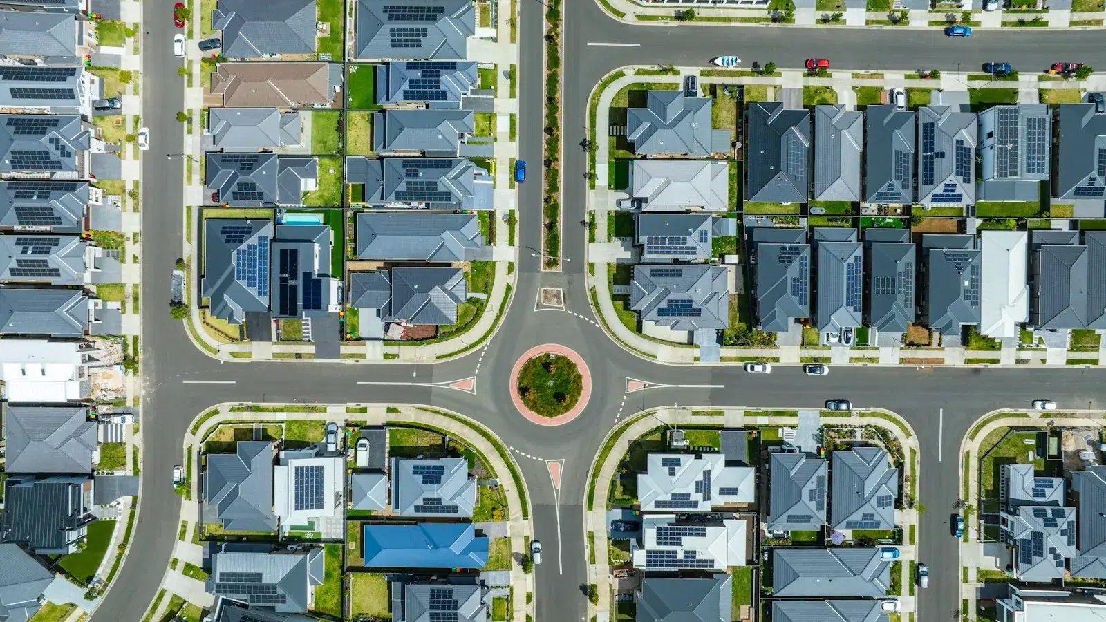 An aerial view of a suburban neighbourhood of houses arranged around a roundabout.