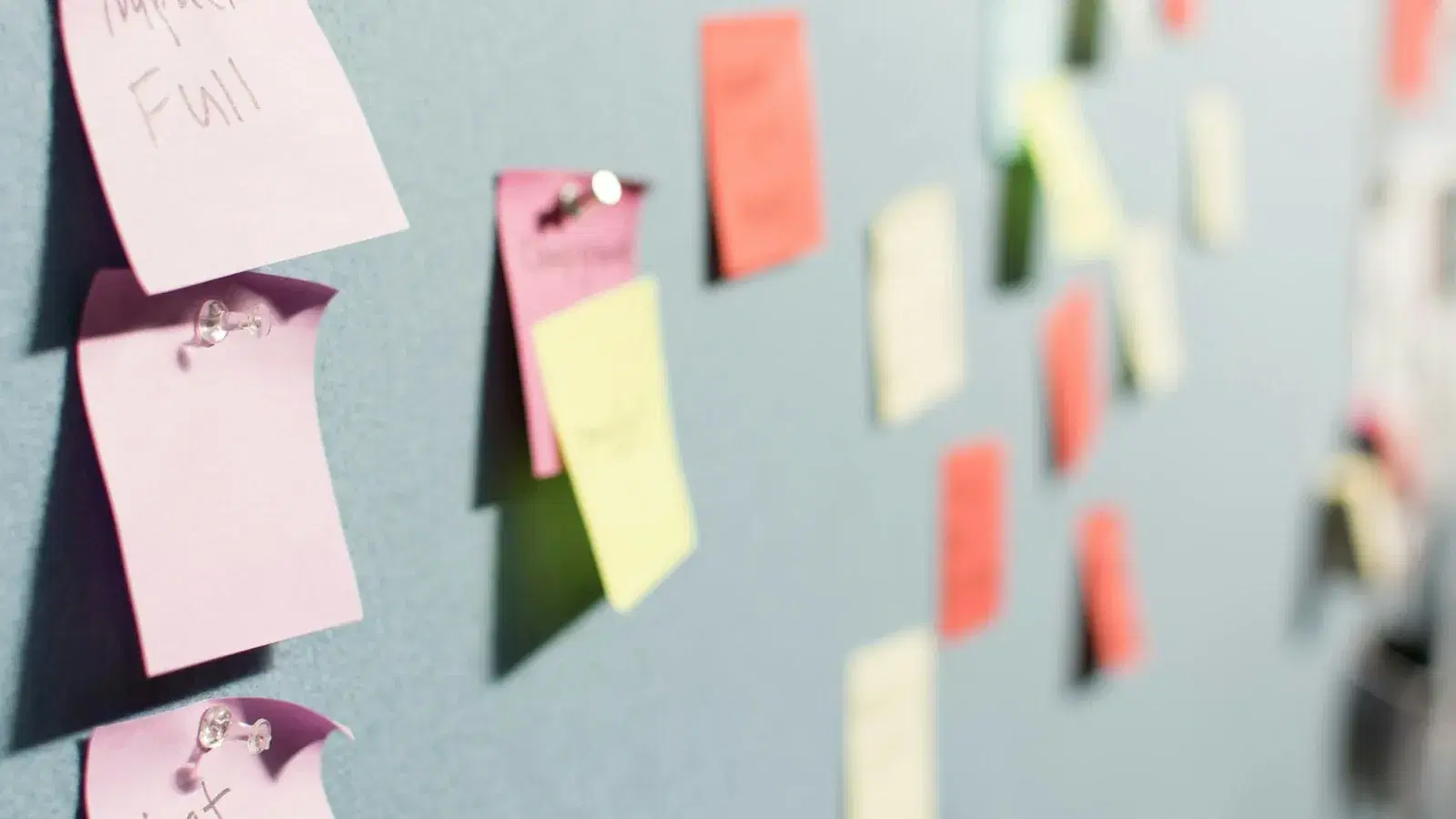 Rows of coloured sticky notes arranged across a planning wall.