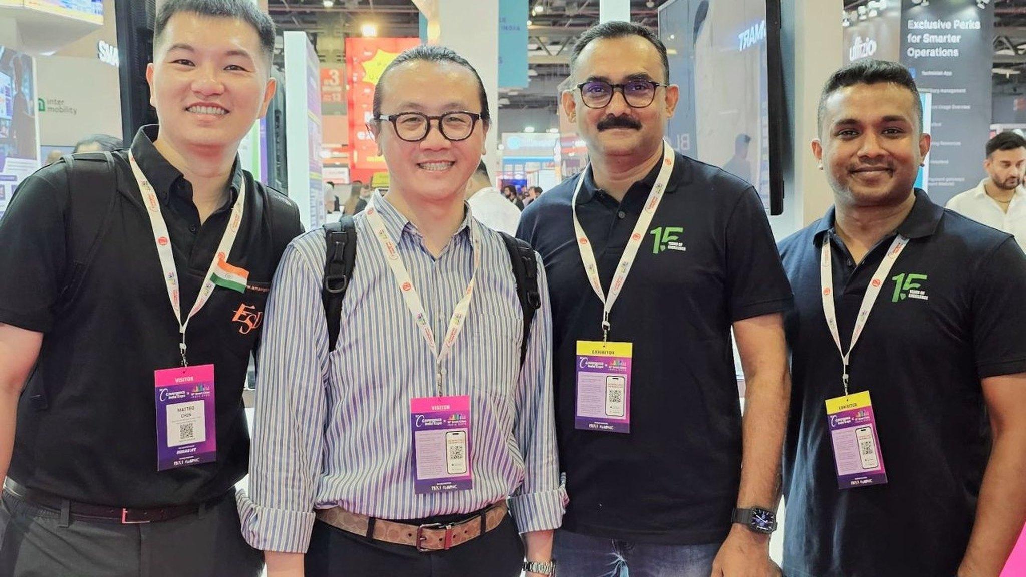 Jaison Joseph and Rino Reji with two visitors at the iLeaf Solutions stand at an industry exhibition