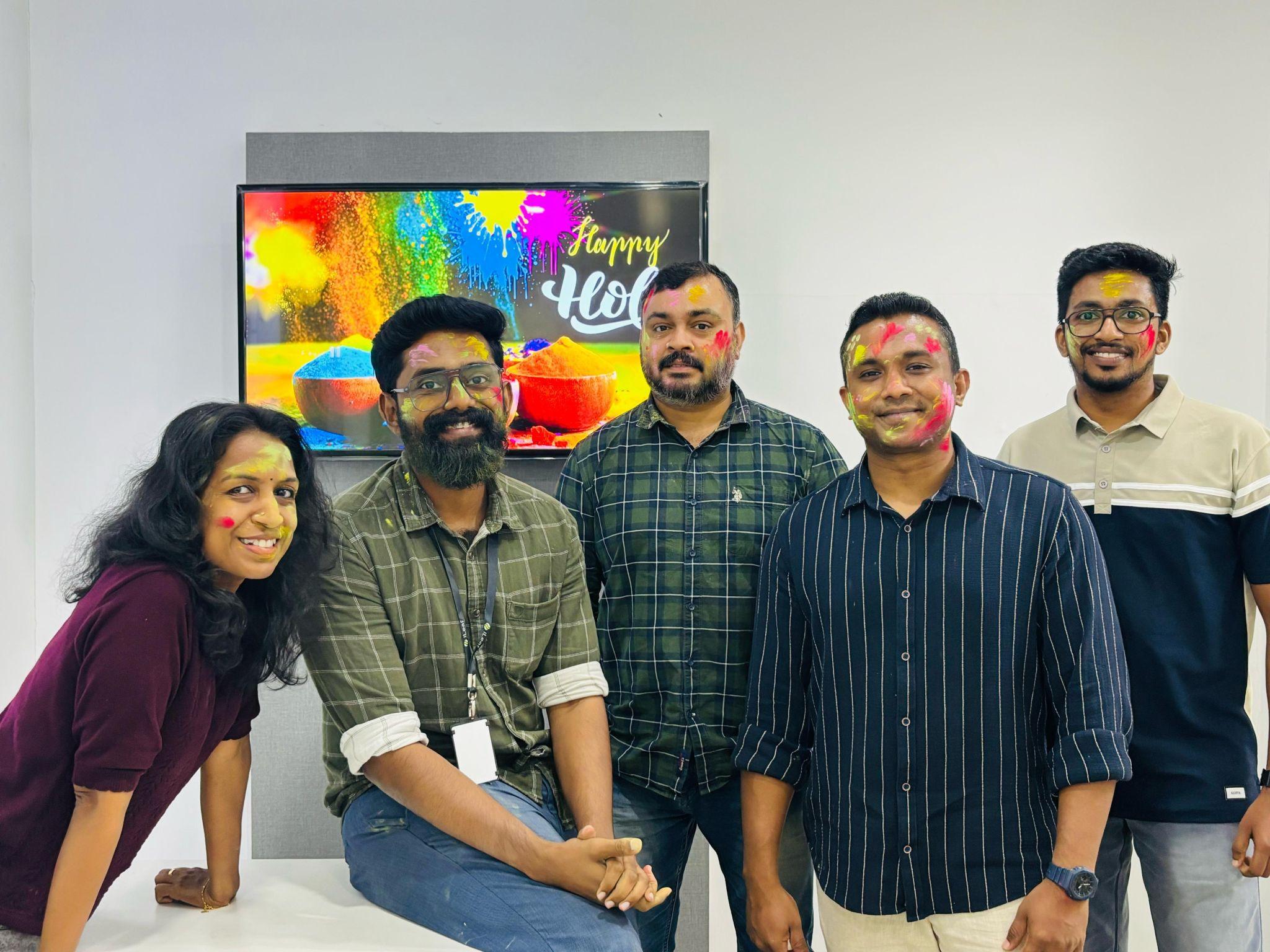 The iLeaf team covered in colour, celebrating Holi at the office