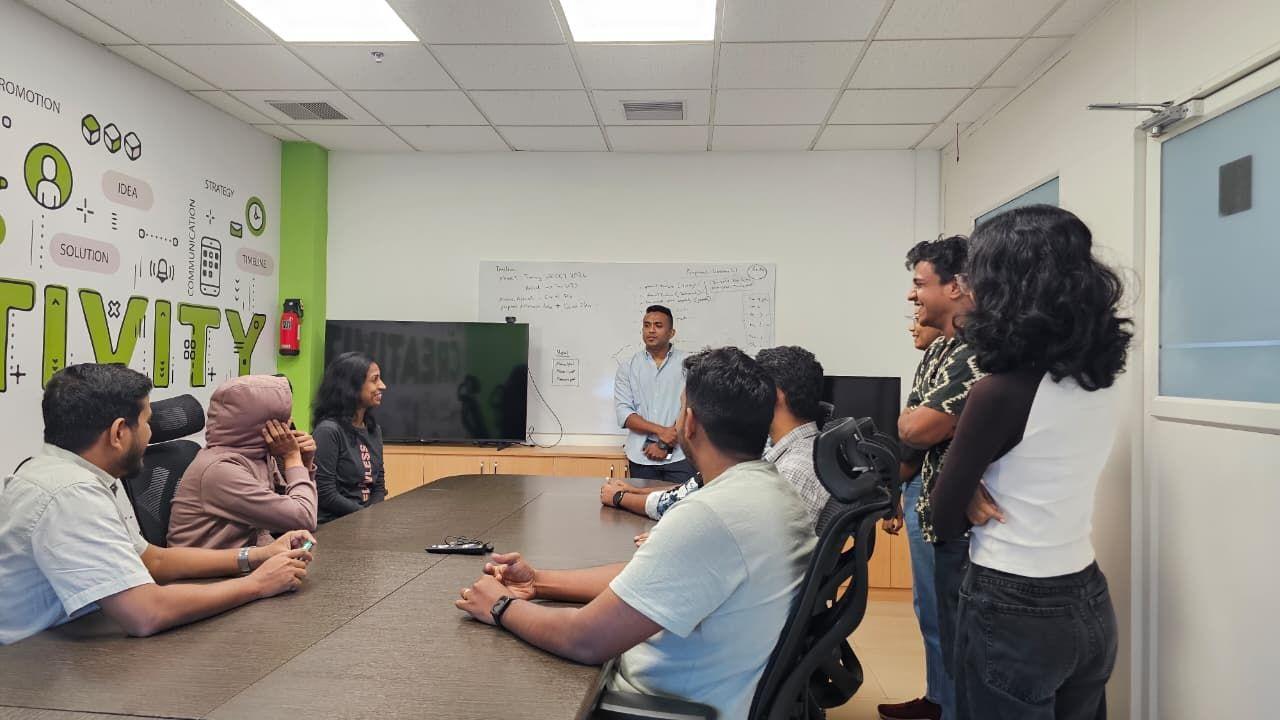 The iLeaf team working through a plan on the whiteboard in the Kochi office