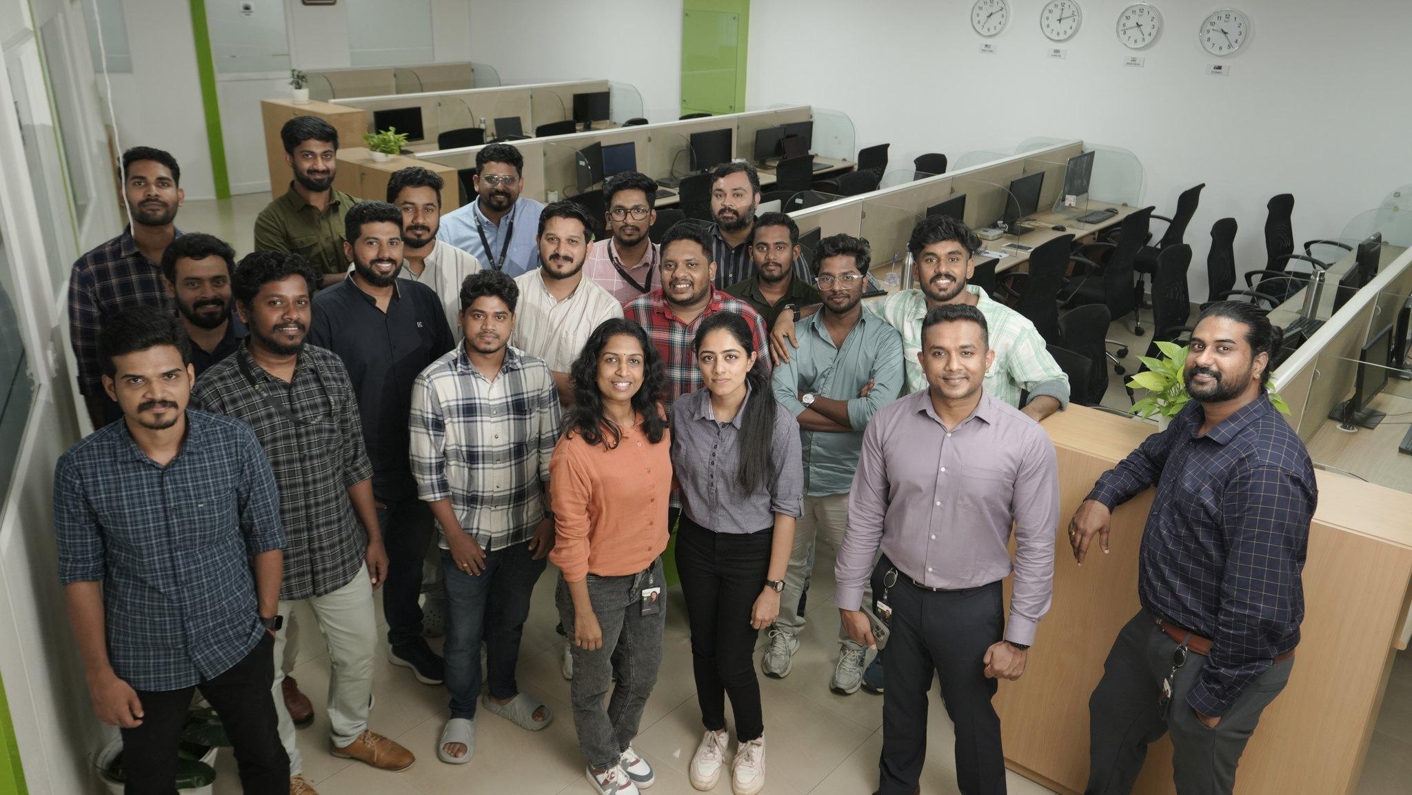 The iLeaf Solutions team standing together in the Kochi office